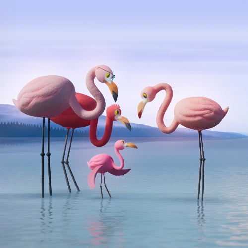 flamingo family standing together in water with mountains in the background